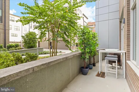 a view of a patio with table and chairs potted plants with wooden fence