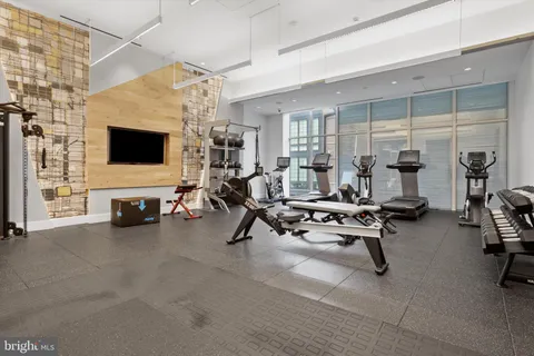 a view of a livingroom with workspace and a window