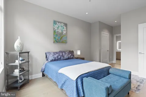 a bedroom with a bed and a lamp