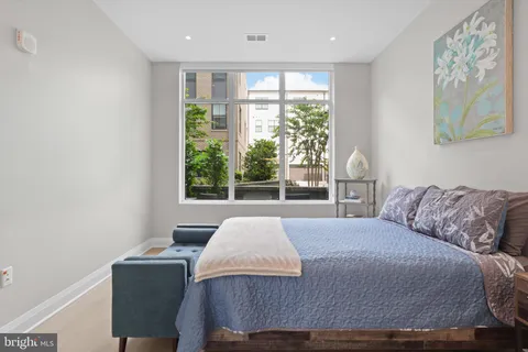 a bedroom with a large bed and a window