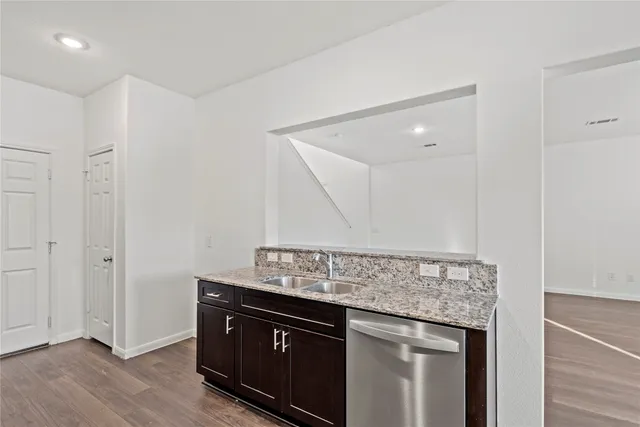 a view of kitchen with granite countertop cabinets and wooden floor