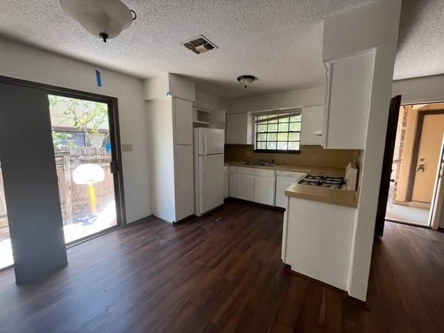 11308 Ptarmigan Drive, Unit B Austin, TX 78758 - Photo 5 of 6 a view of an empty room with a window and wooden floor