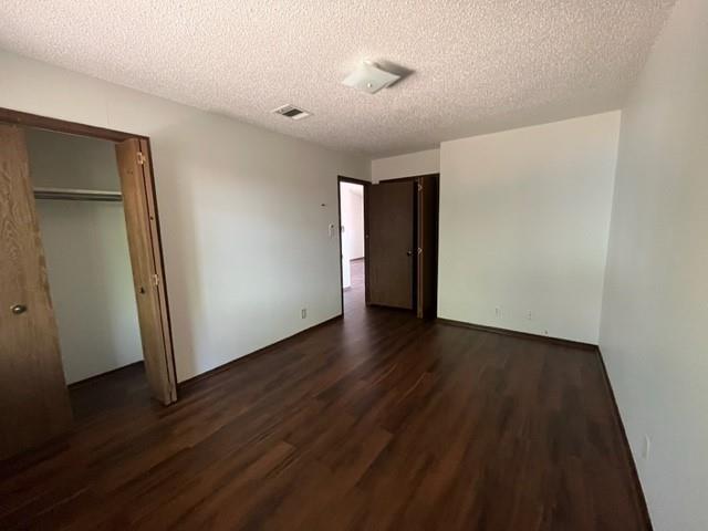 11308 Ptarmigan Drive, Unit B Austin, TX 78758 - Photo 6 of 6 an empty room with wooden floor and windows