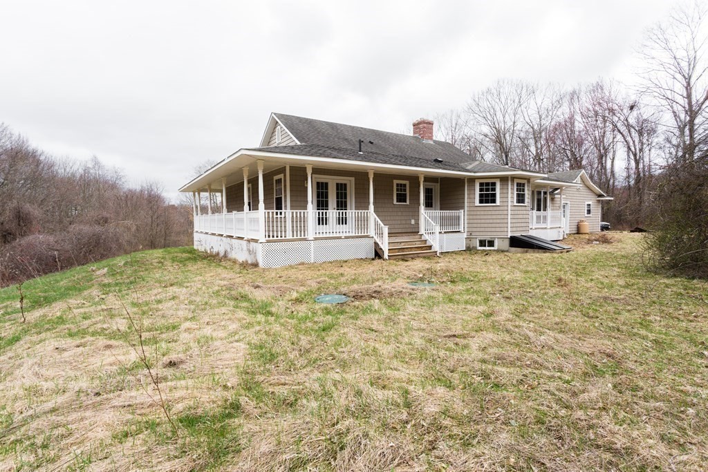 147 Ragged Hill Road West Brookfield, MA 01585 - Photo 27 of 42 a house with trees in the background