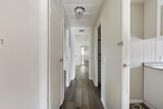 a view of a hallway with wooden floor