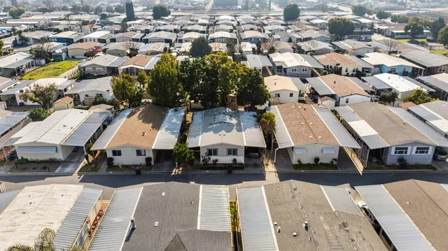 an aerial view of multiple houses with yard