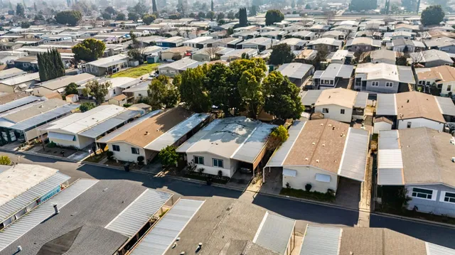 an aerial view of a building with streets and trees