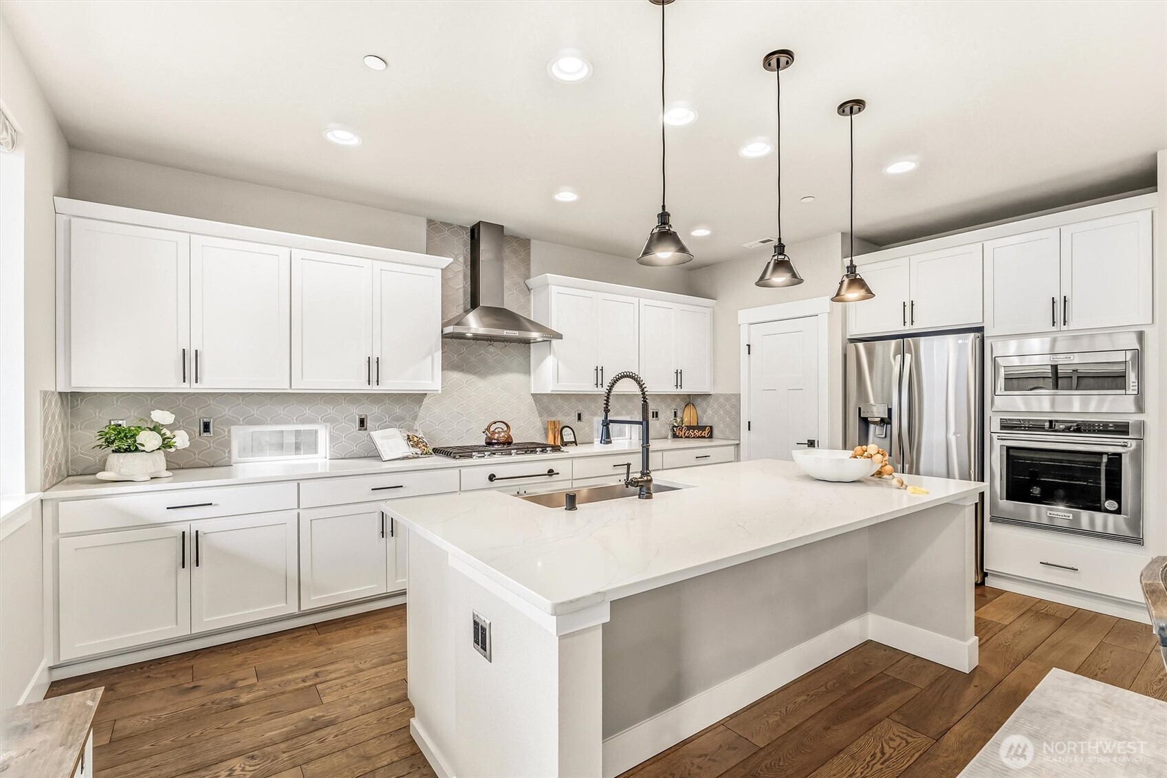4418 242nd Place Southeast Bothell, WA 98021 - Photo 13 of 40 a kitchen with a sink a stove and cabinets