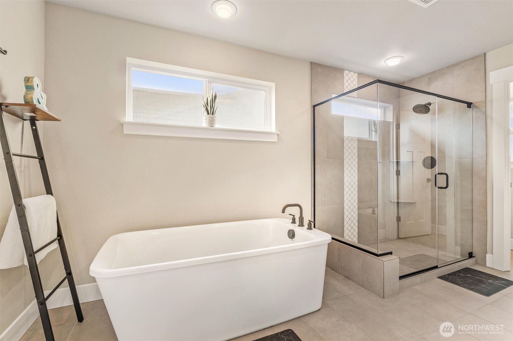 4418 242nd Place Southeast Bothell, WA 98021 - Photo 25 of 40 a white bath tub sitting next to a shower