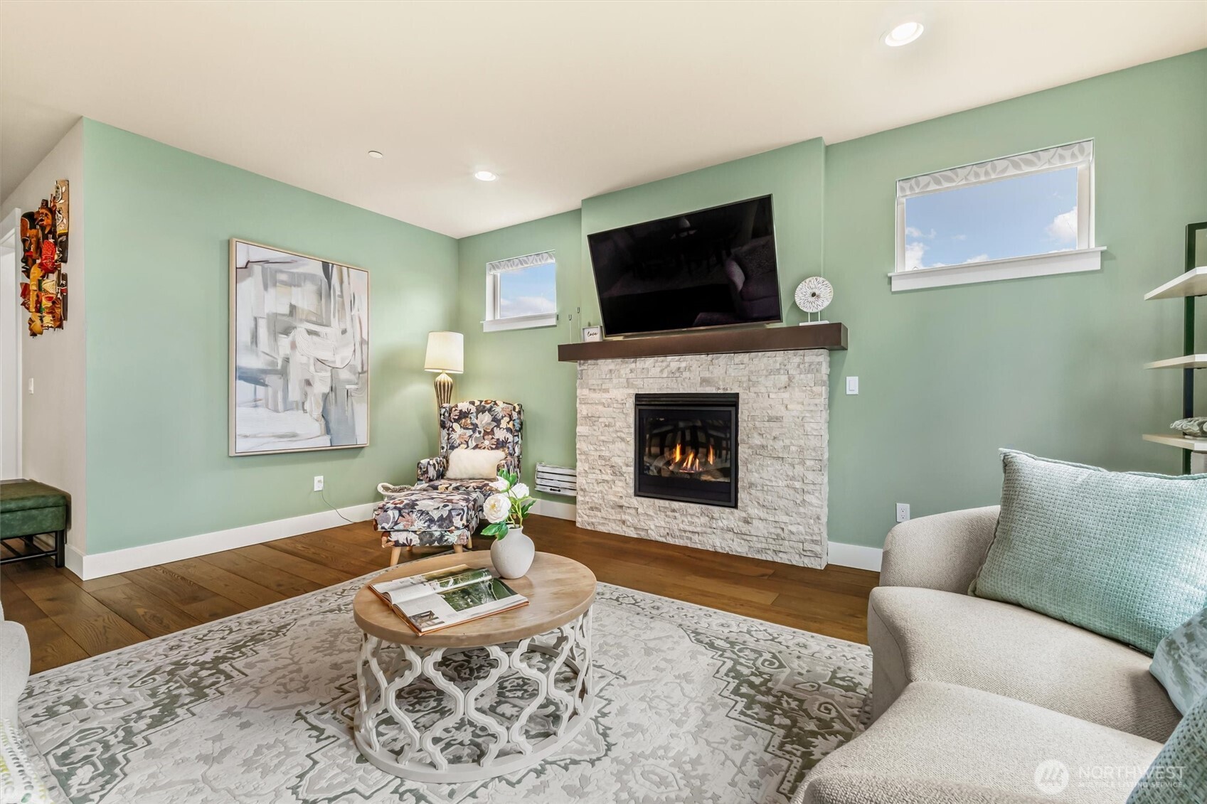 4418 242nd Place Southeast Bothell, WA 98021 - Photo 9 of 40 a living room with furniture a flat screen tv and a fireplace