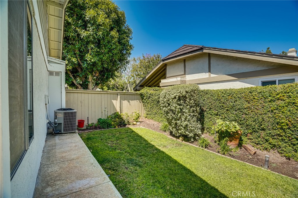 49 East Yale Loop, Unit 26 Irvine, CA 92604 - Photo 49 of 63 a front view of a house with a yard