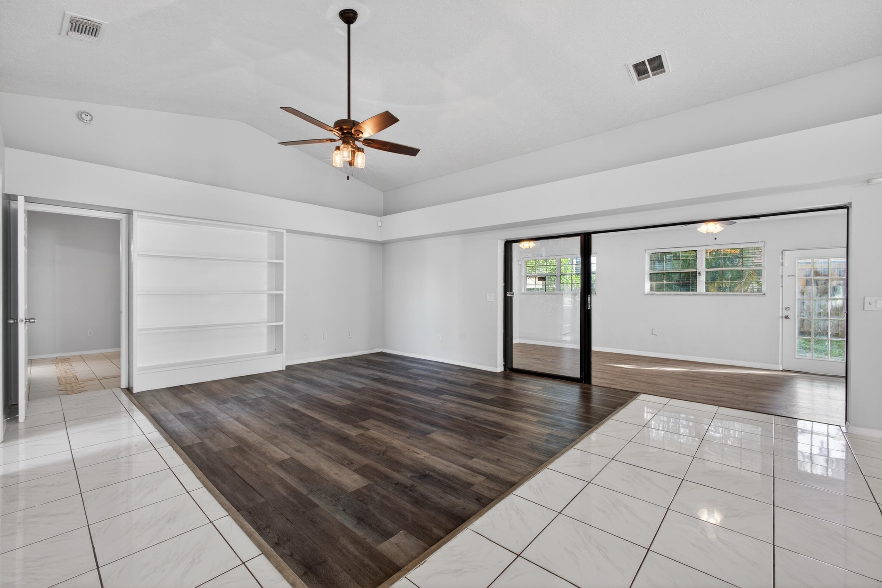 566 Southeast Damask Avenue Port St. Lucie, FL 34983 - Photo 13 of 30 a view of empty room with wooden floor and fan