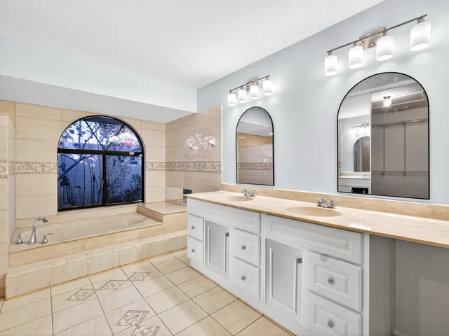 an empty room with closet and fan