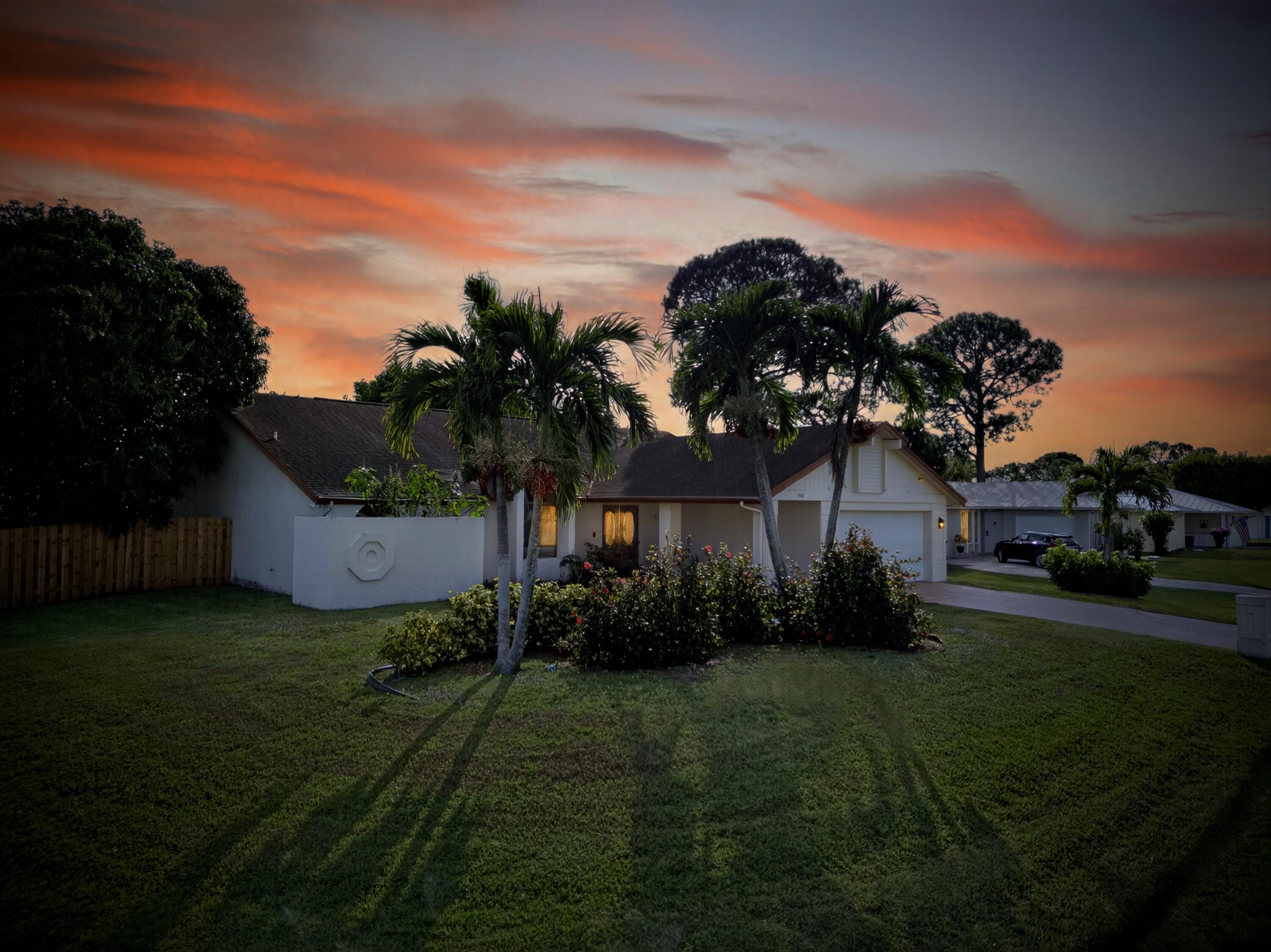 566 Southeast Damask Avenue Port St. Lucie, FL 34983 - Photo 2 of 30 a front view of a house with garden