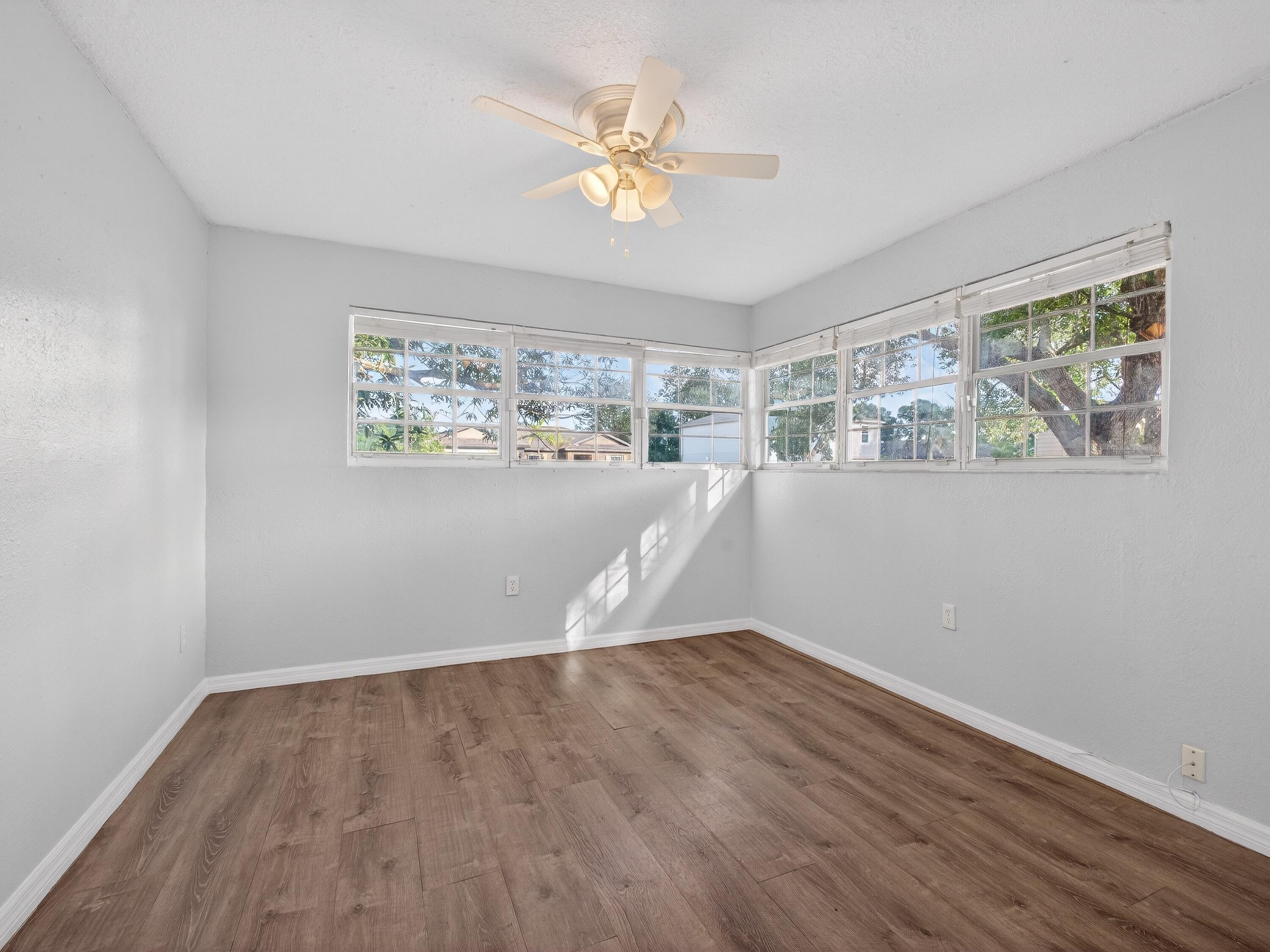 566 Southeast Damask Avenue Port St. Lucie, FL 34983 - Photo 23 of 30 a view of an empty room with wooden floor and a window