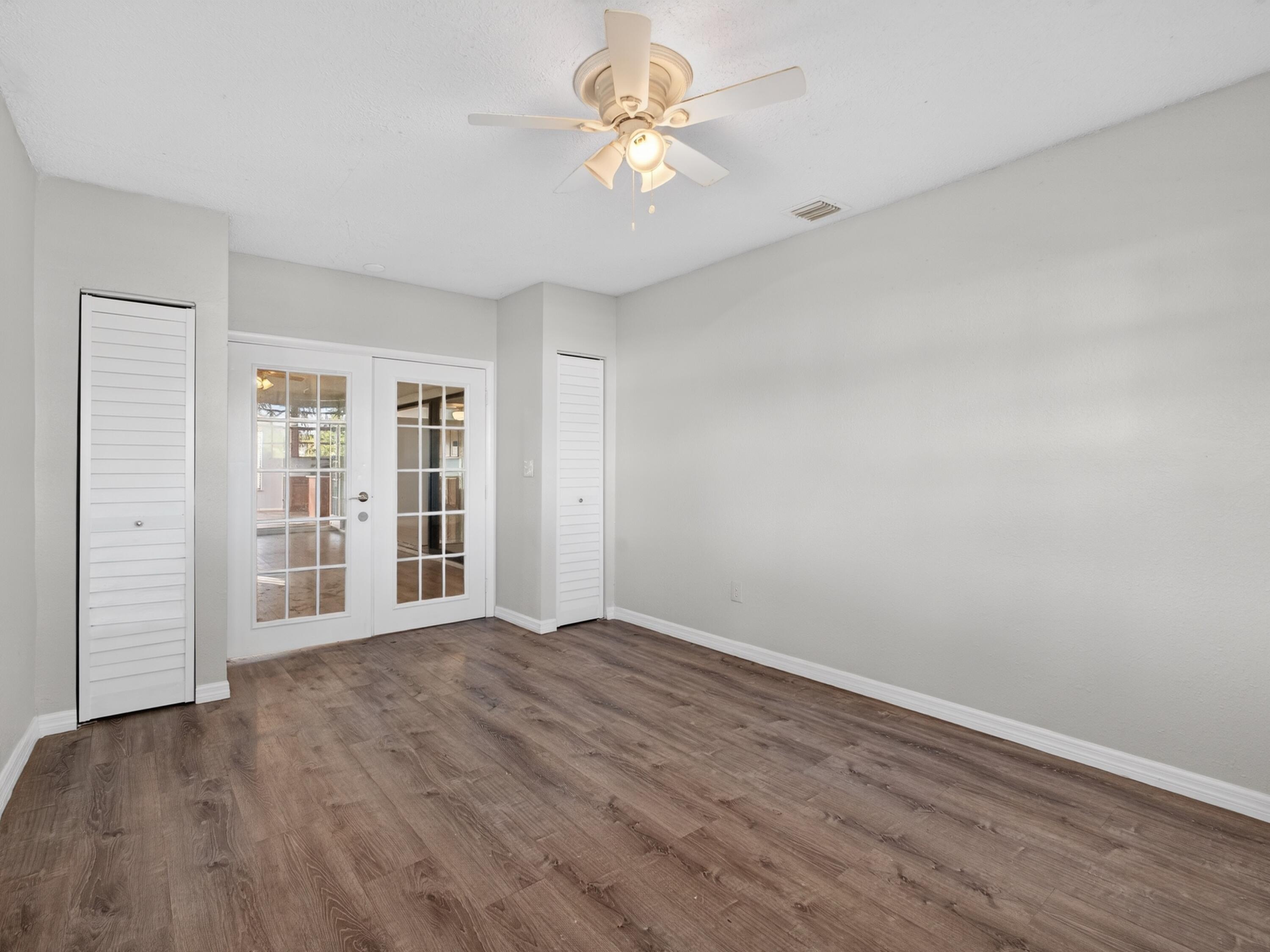 566 Southeast Damask Avenue Port St. Lucie, FL 34983 - Photo 24 of 30 a view of an empty room with a window and a kitchen