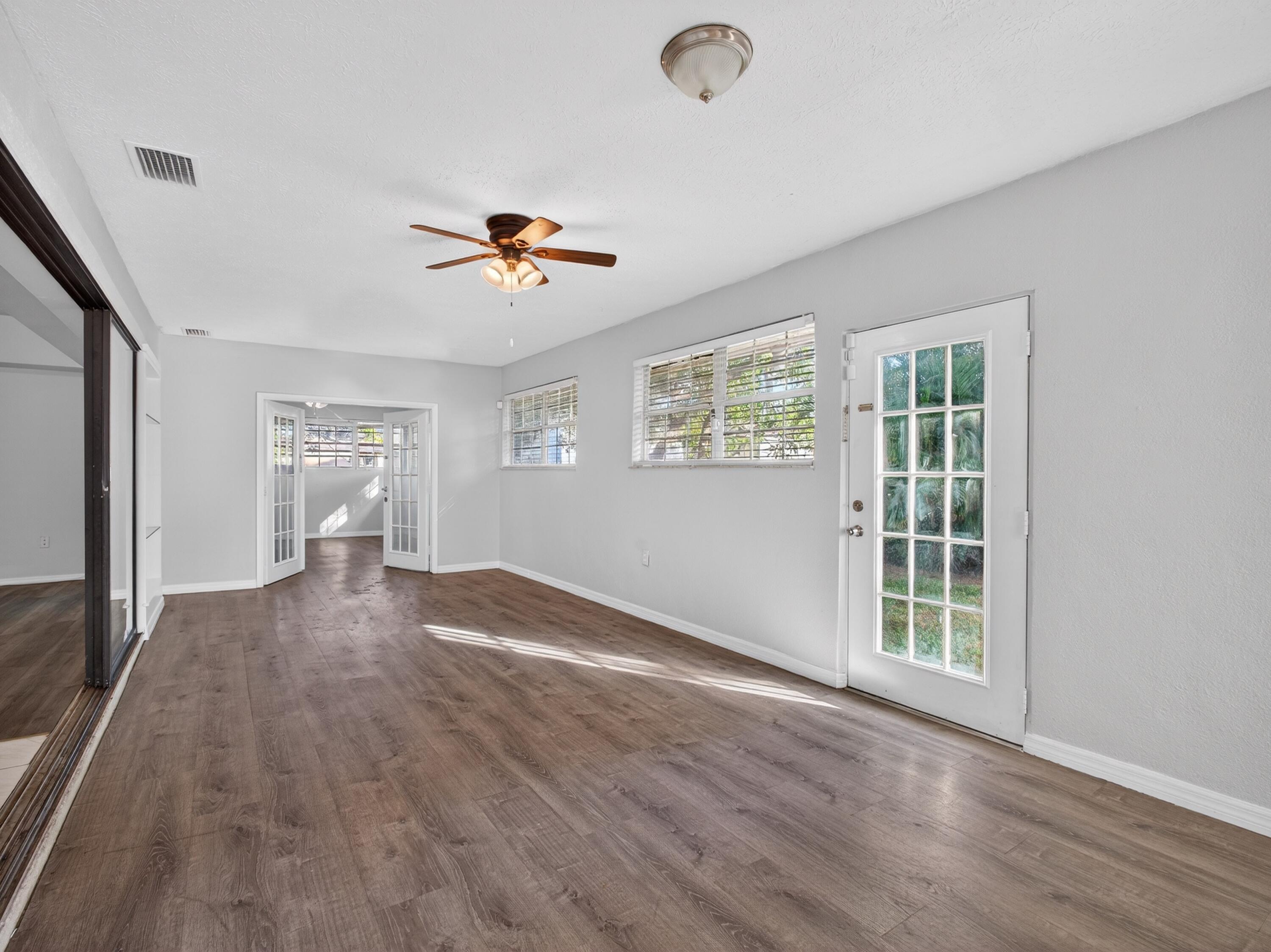 566 Southeast Damask Avenue Port St. Lucie, FL 34983 - Photo 25 of 30 a view of an empty room with a window and wooden floor