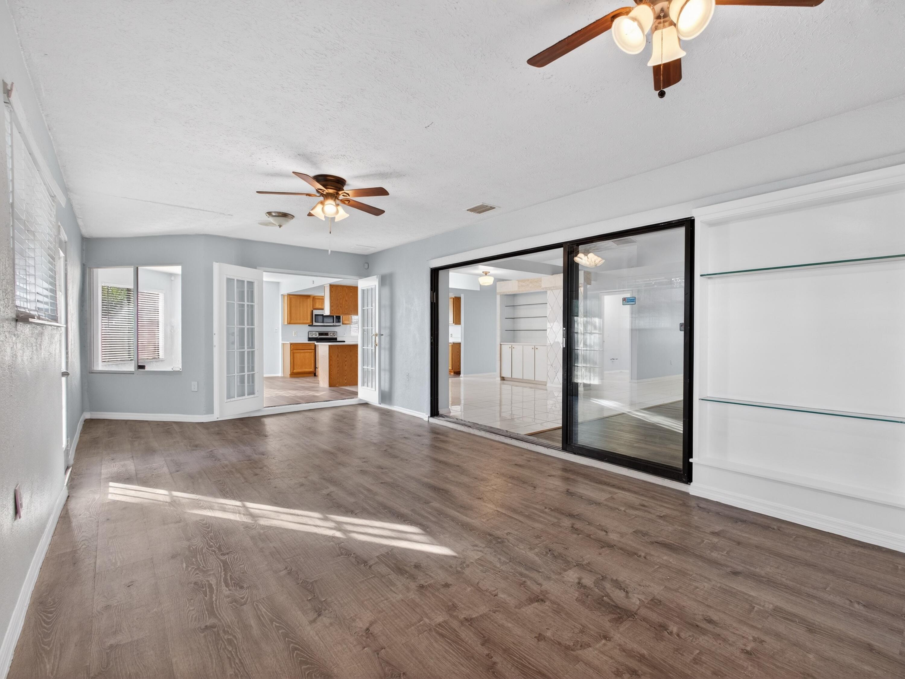 566 Southeast Damask Avenue Port St. Lucie, FL 34983 - Photo 26 of 30 a view of an empty room with a window and a ceiling fan