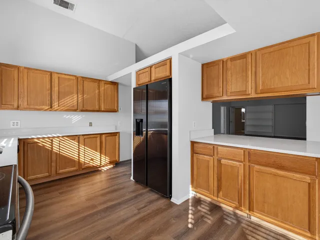 a kitchen with granite countertop a refrigerator and a stove