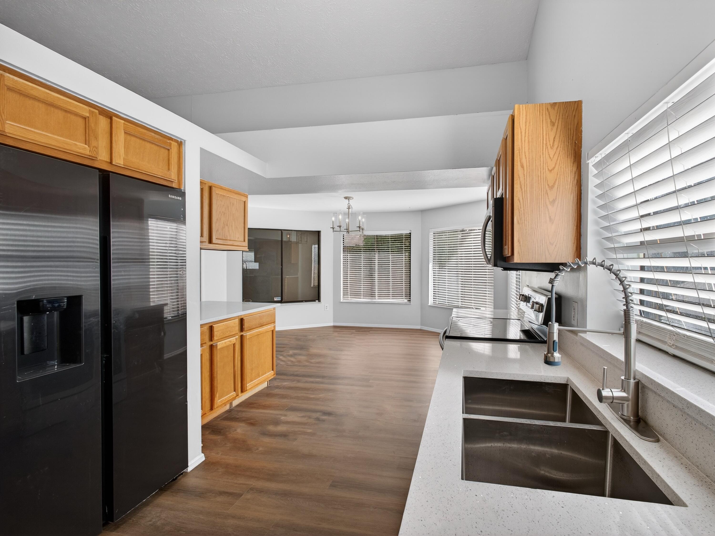 566 Southeast Damask Avenue Port St. Lucie, FL 34983 - Photo 9 of 30 a kitchen with granite countertop a refrigerator and a stove