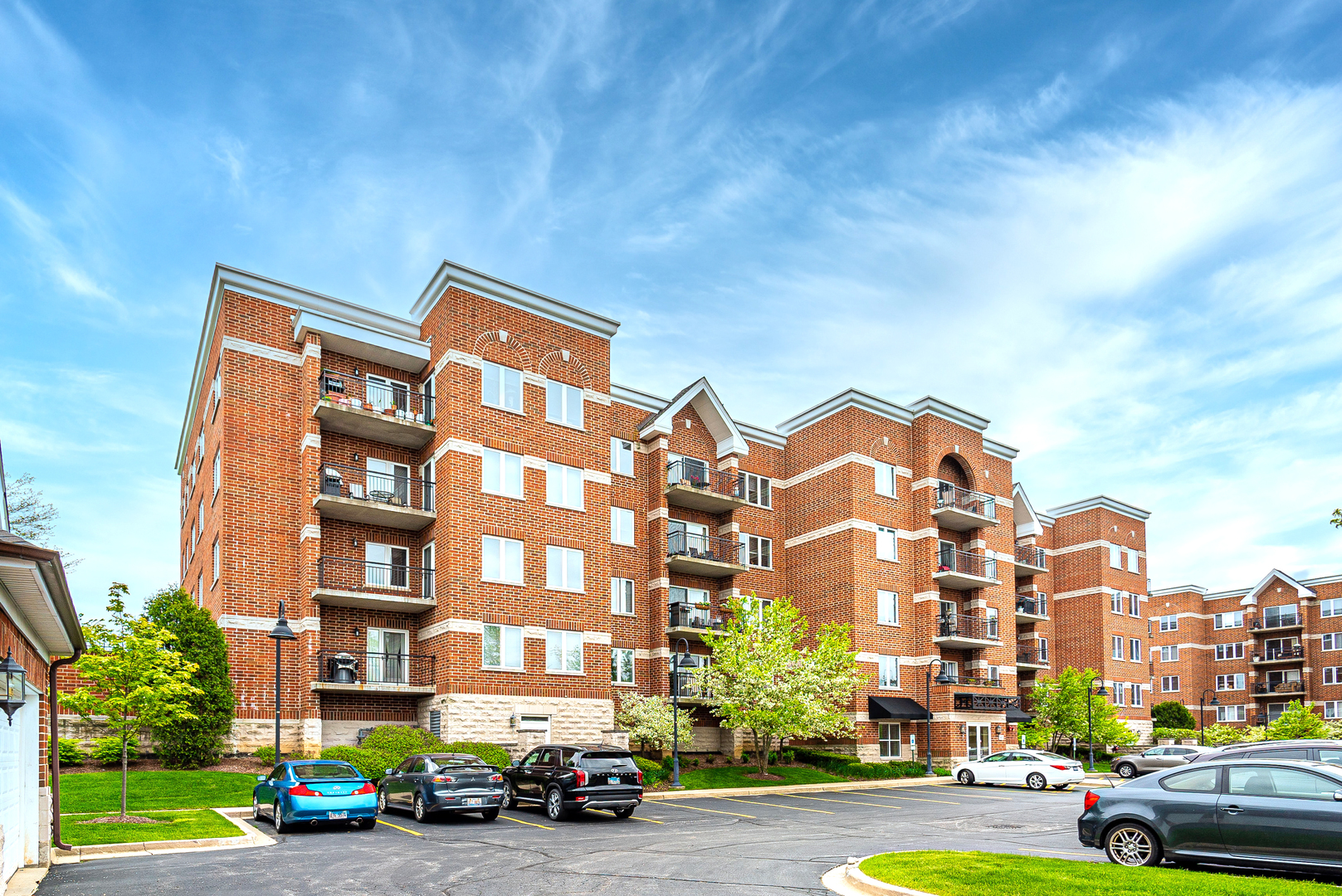 a city street lined with buildings and cars parked in front of it
