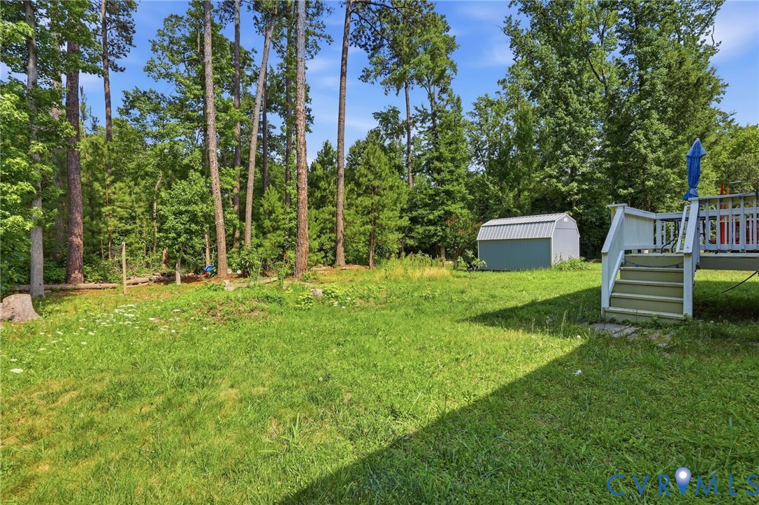 10155 Virginia Road Glen Allen, VA 23060 - Photo 46 of 50 Expansive backyard featuring a green lawn, mature