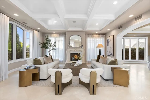 a living room with furniture fireplace and large window