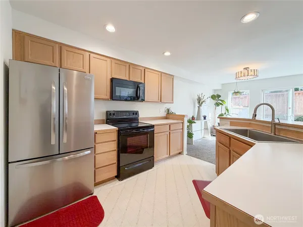 a kitchen with stainless steel appliances a refrigerator stove and sink