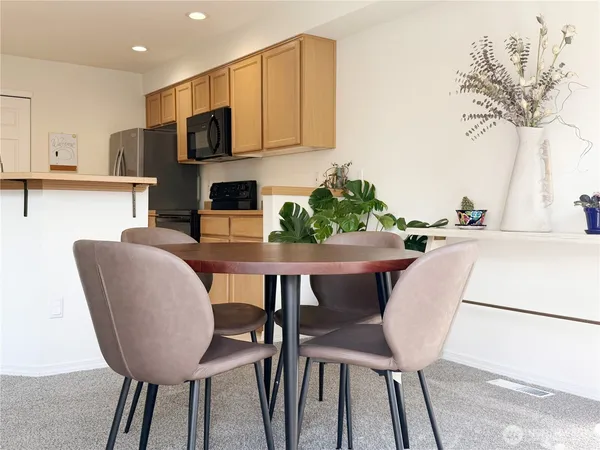 a view of a dining room with furniture and a potted plant