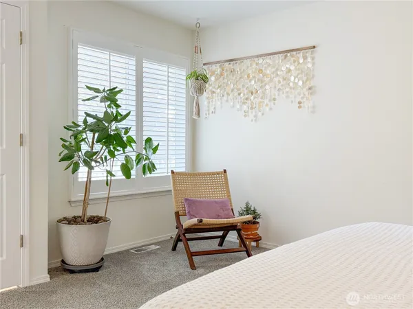 a bench sitting in a room next to a window