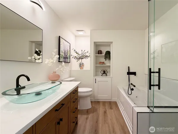 a bathroom with a sink a toilet and shower