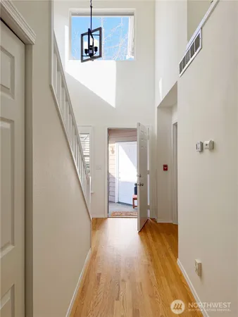 a view of a hallway view with wooden floor and staircase