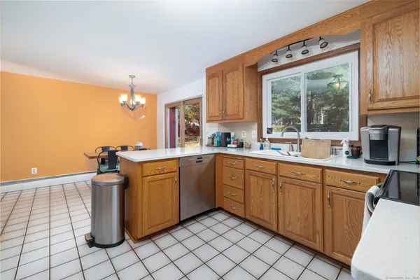 a kitchen with a sink cabinets and window