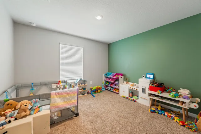 a playing room with toys and a couch