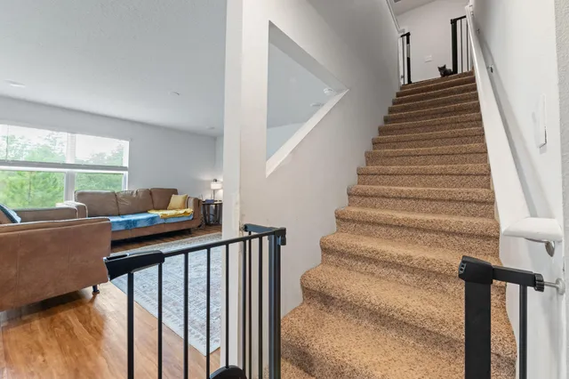 a view of entryway and hall with wooden floor