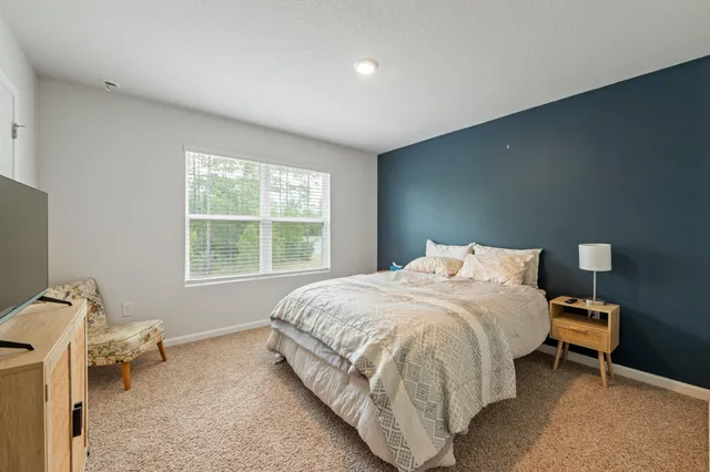 a bed room with a bed and a window