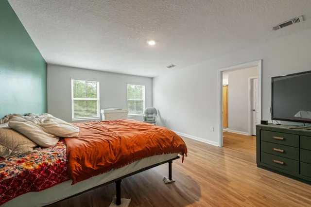 a bedroom with a bed and a flat screen tv
