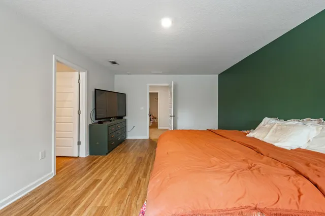 a bed room with a bed and a television