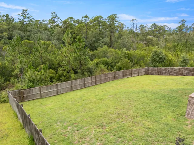 a view of a swimming pool with a yard