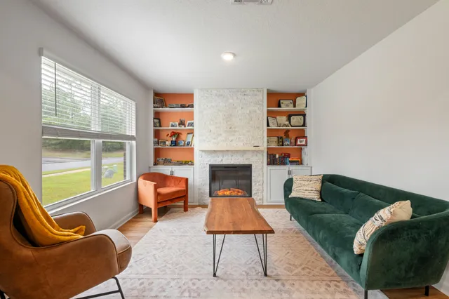 a living room with furniture and a fireplace