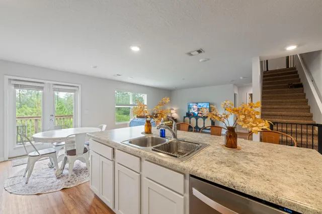 a kitchen with sink and view of living room