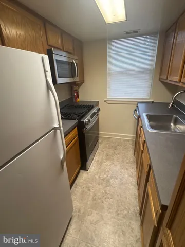 a stove top oven sitting inside of a kitchen