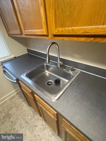 a kitchen with a sink a stove and cabinets