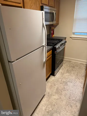 a kitchen with a stove and a refrigerator