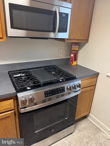 a kitchen with a stove and a microwave
