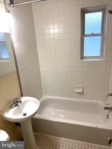 a bathroom with a light fixture and a shower