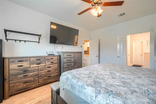 a bedroom with a large bed and a chandelier