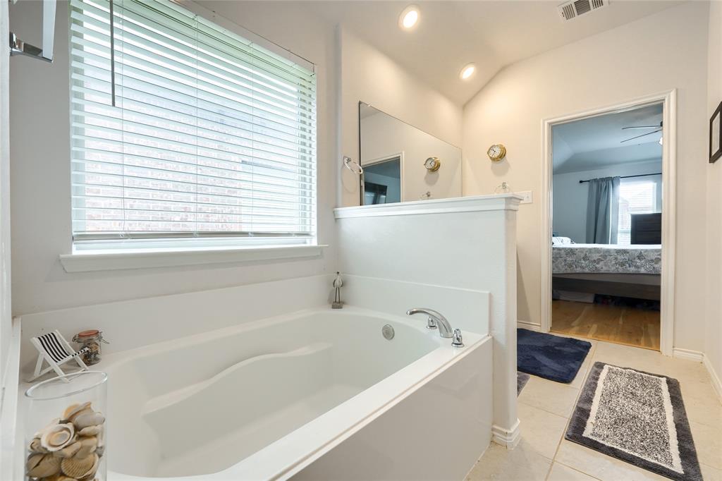 5604 Durst Lane Forney, TX 75126 - Photo 16 of 31 a en suite bathroom with a bathtub and a window
