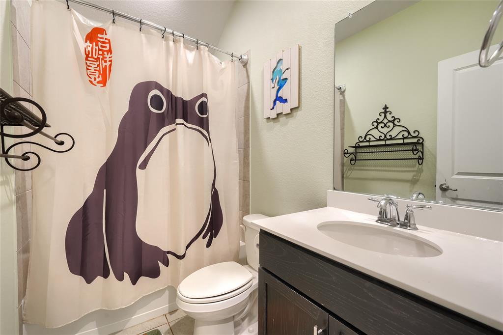 5604 Durst Lane Forney, TX 75126 - Photo 19 of 31 a bathroom with a toilet sink and mirror