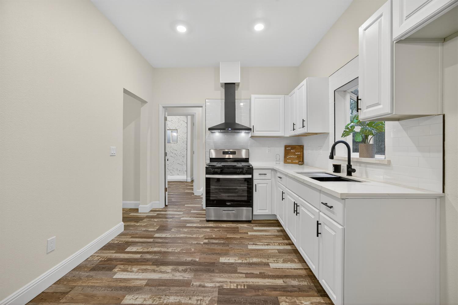 400 Pacific Lodi, CA 95242 - Photo 28 of 50 a kitchen with granite countertop a sink and a stove